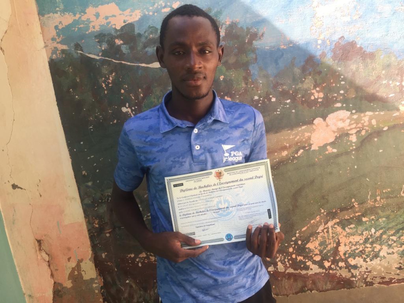 Arouna with his baccalauréat diploma.